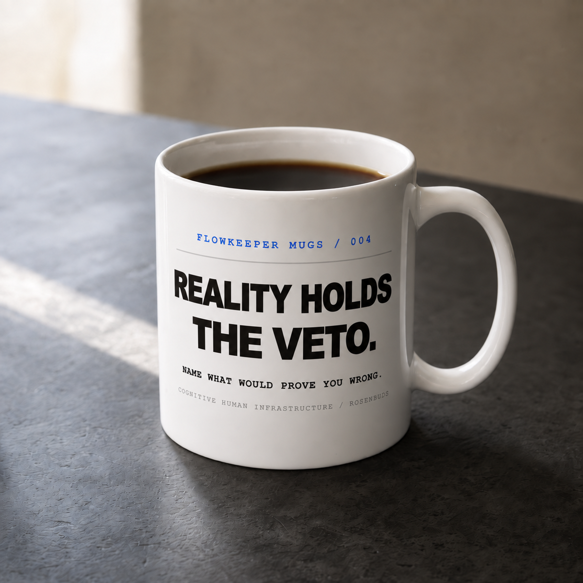 White 11 oz Flowkeeper Mug printed with 'Reality Holds the Veto.'