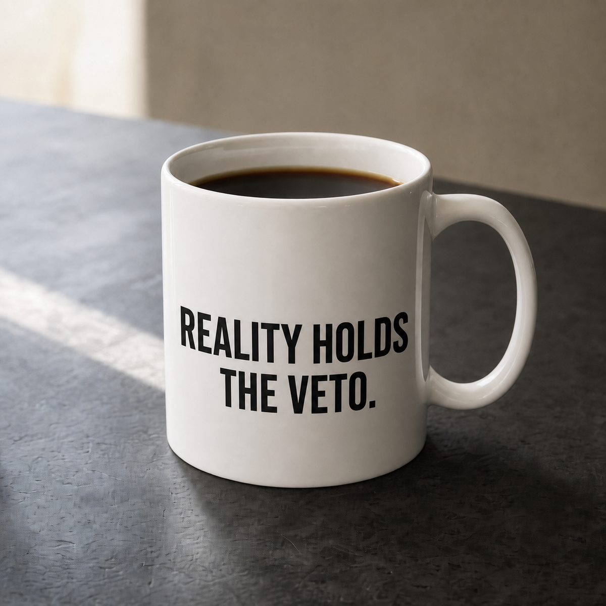 White 11 oz Flowkeeper Mug printed with 'Reality Holds the Veto.'
